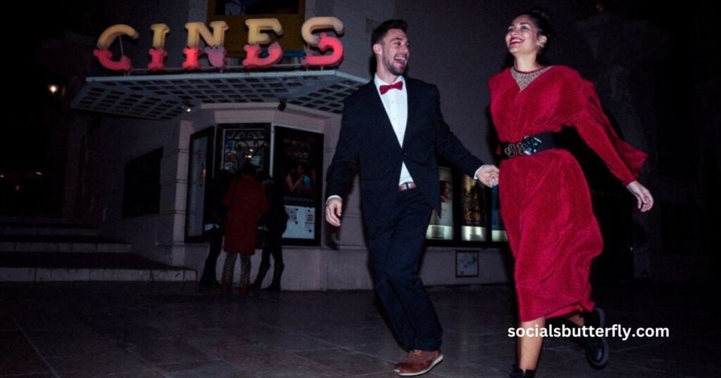 A man and woman in formal attire stroll past a cinema, embodying elegance and sophistication, with "Silverstein" in focus.